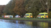Onwel geworden persoon met fiets te water in Assen